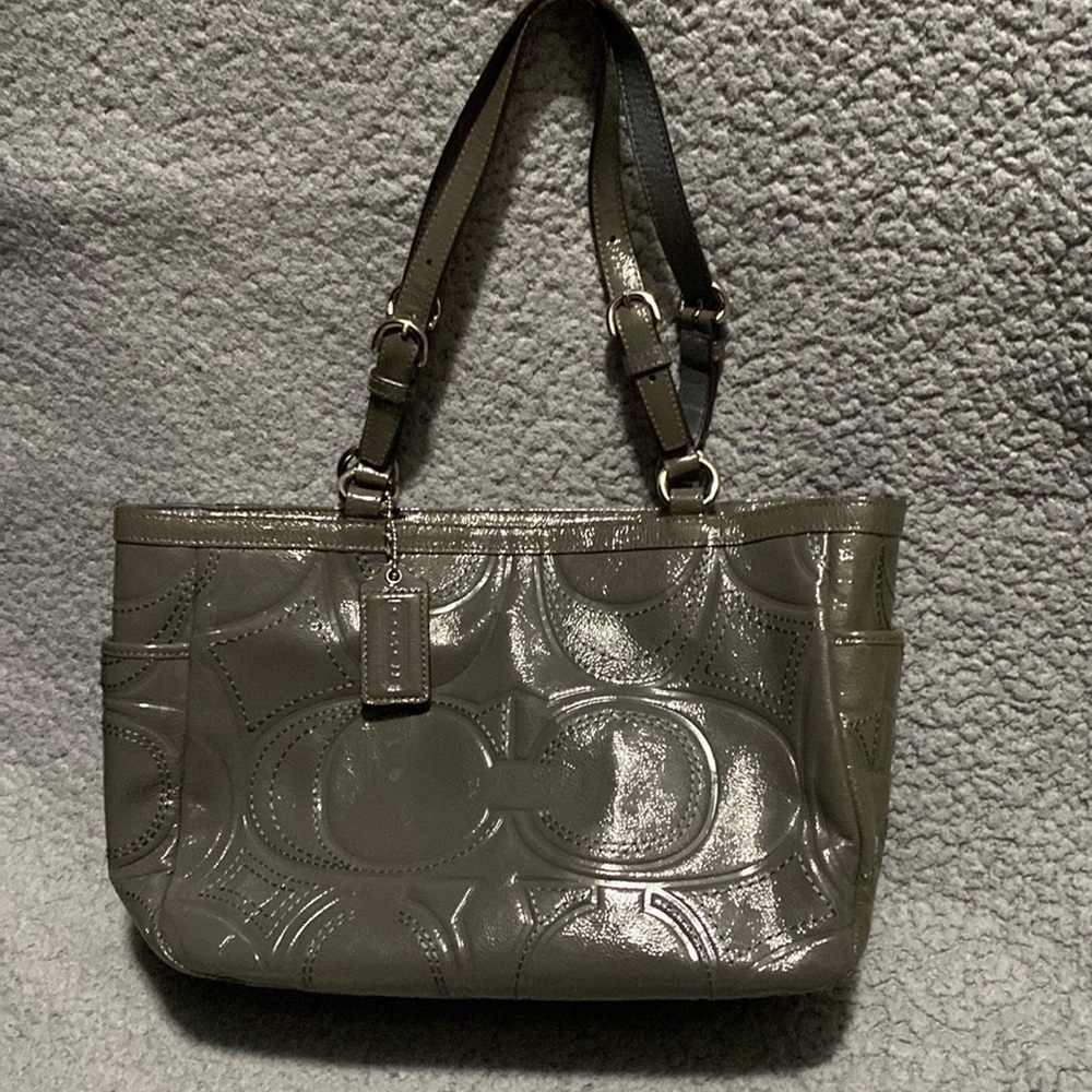 Prelived, slightly used gray coach purse.
